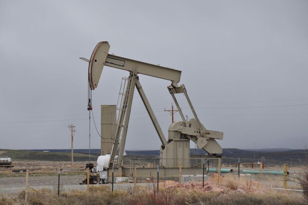 oil and gas drilling rig in rural countryside field, no people