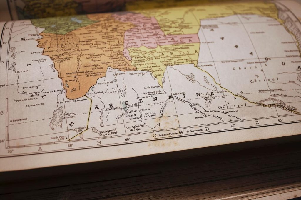cadastral map document with property boundary lines on a desk, no faces visible