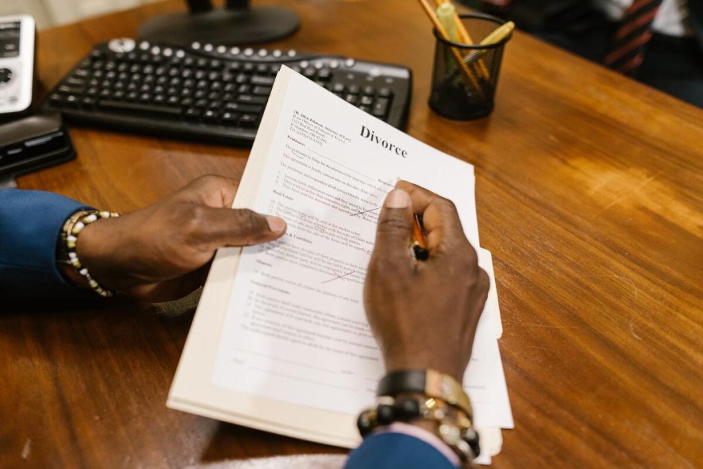 stack of legal property documents with a pen on a wooden desk, notary office setting