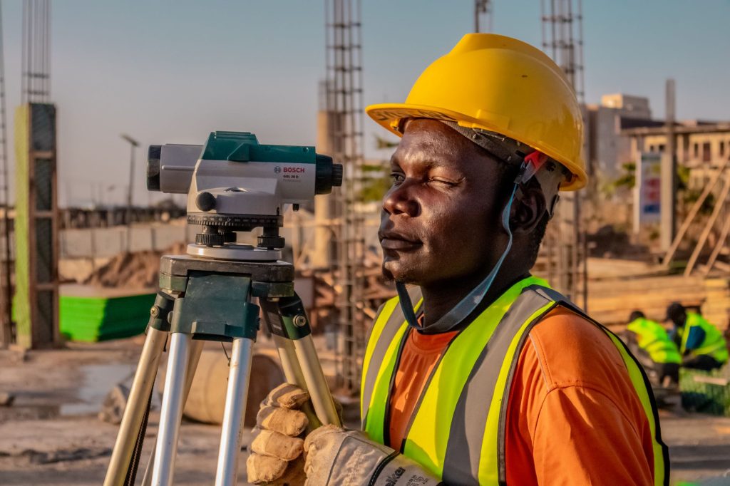 land surveyor measuring with GPS equipment on agricultural field